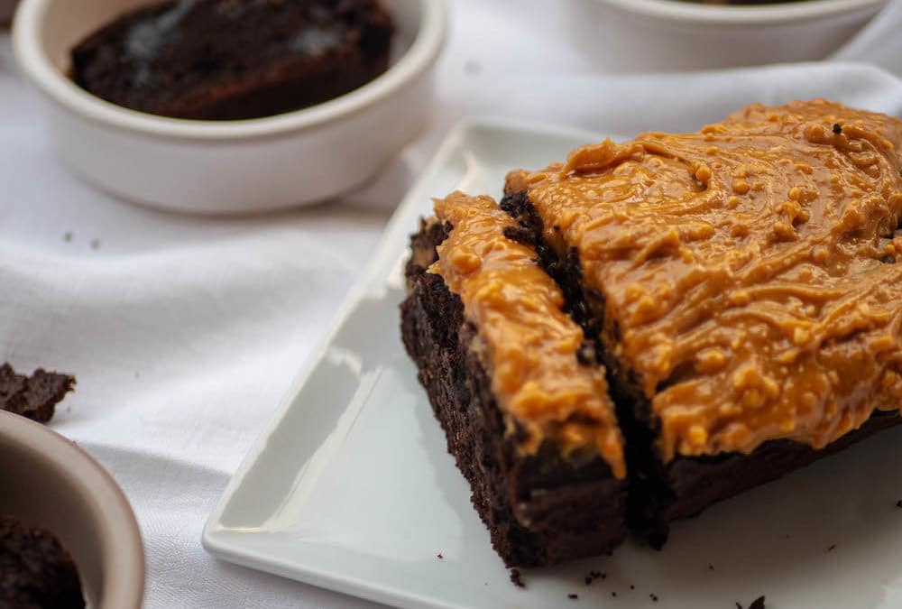 Gluten-free chocolate cake and butter-free with peanut butter and maple syrup topping